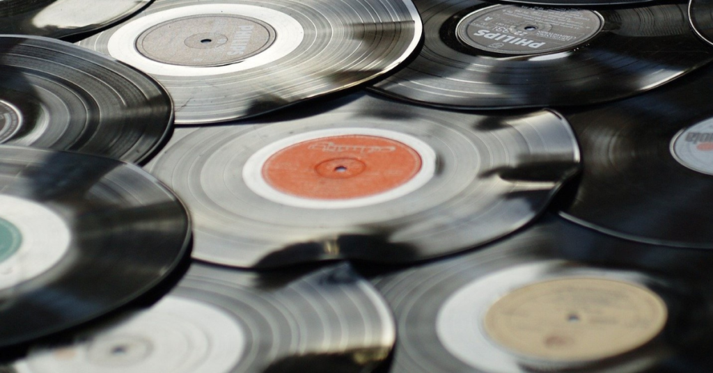 Vinyl records spread across the floor